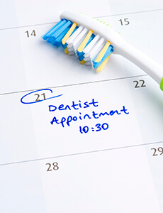 Toothbrush on calendar with Dentist Appointment note