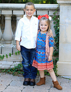 Two smiling children outdoors