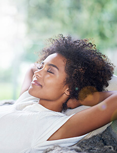 Relax woman with hands behind head